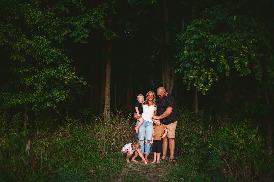 Family standing in a field at golden hour