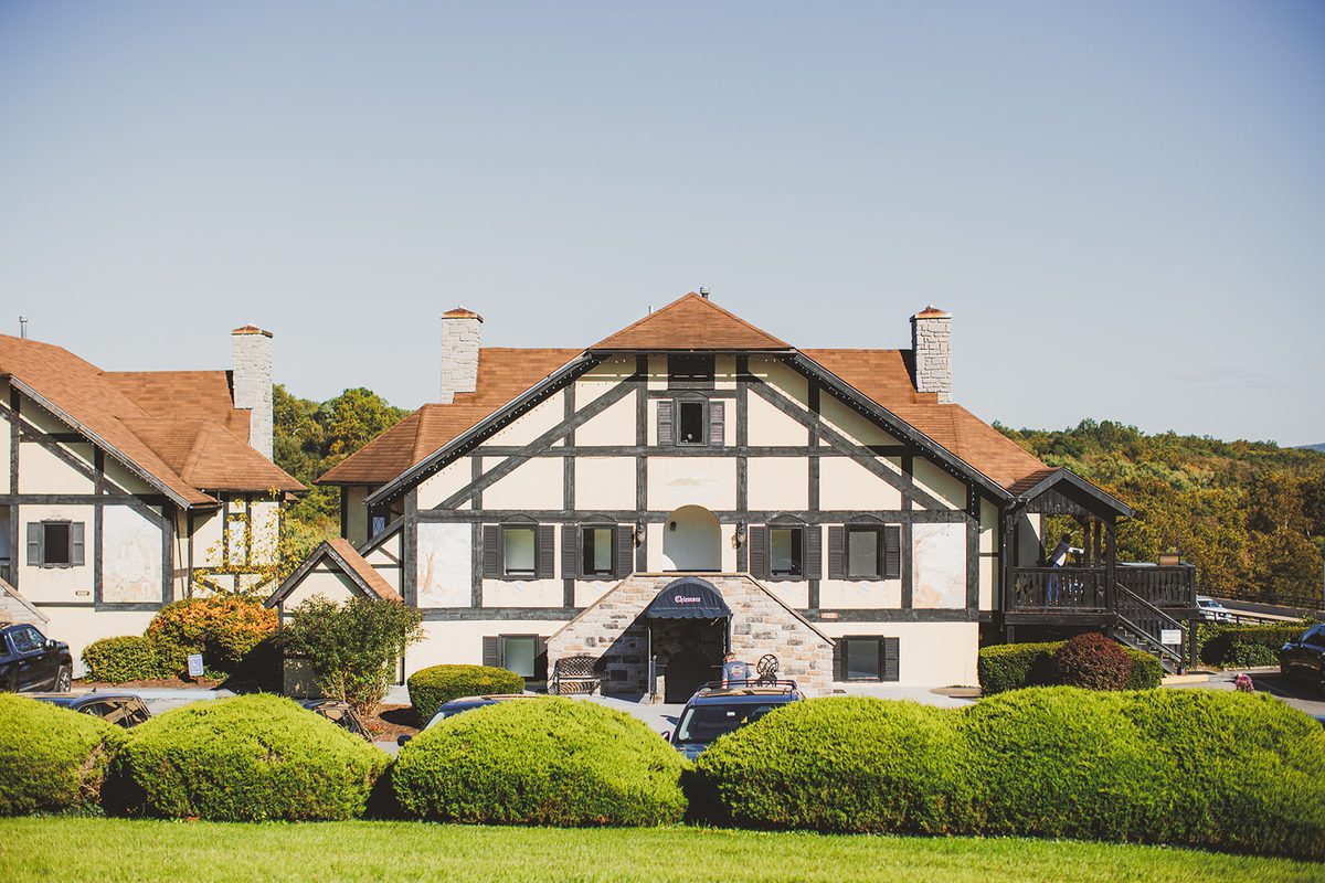 The half-timbered Tudor chalets of the Bavarian Inn under a clear morning sky