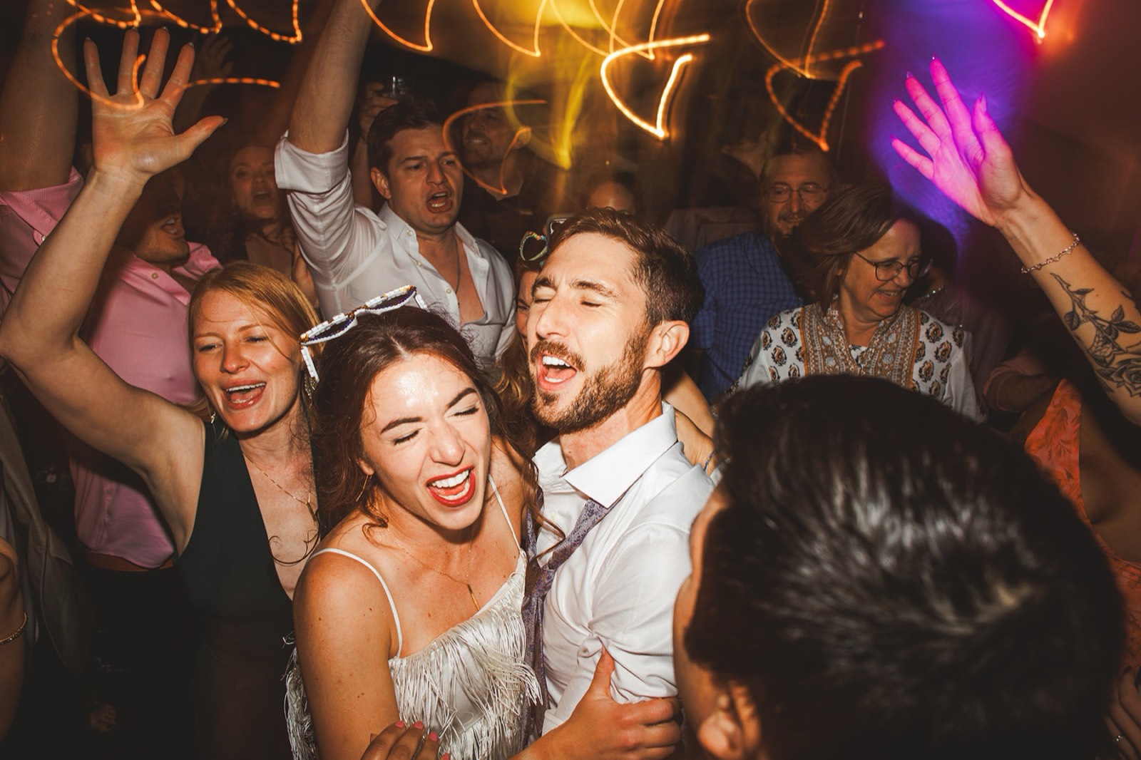 Andrea and Patrick singing together in the middle of a packed dance floor at the Bavarian Inn