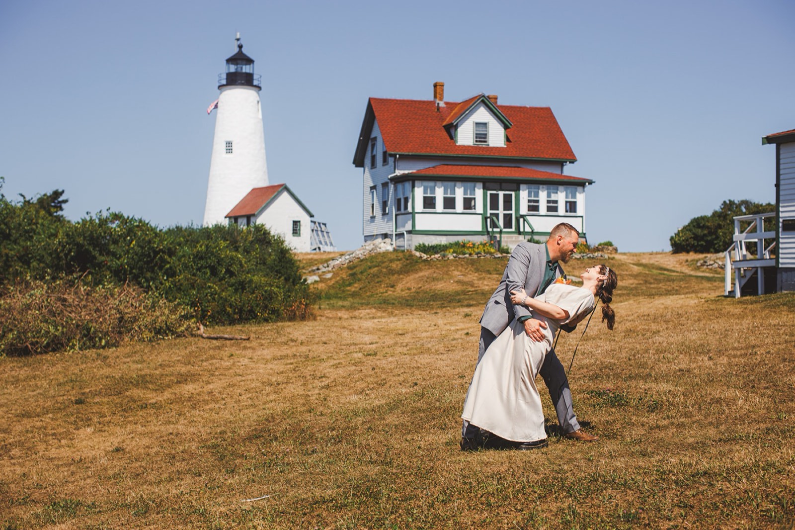 Casey and Jamie dipping on the lawn below the Bakers Island lighthouse