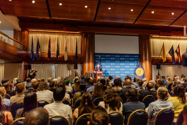 A packed National Press Club ballroom listening to Bernie Sanders speak from the podium.