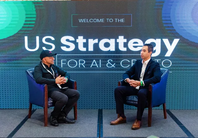 Two armchairs on a stage under a Welcome to the US Strategy for AI and Crypto sign.