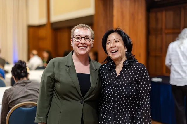 Two women laughing together.