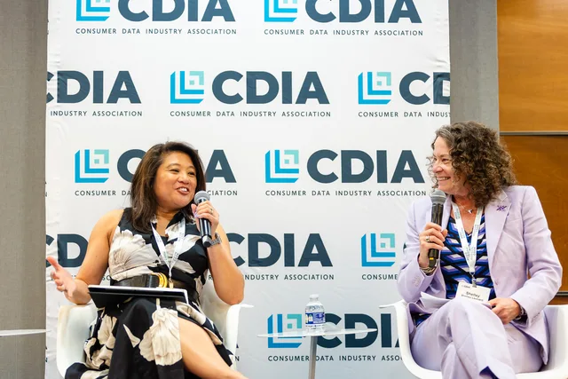 Two panelists with mics seated against the CDIA backdrop.