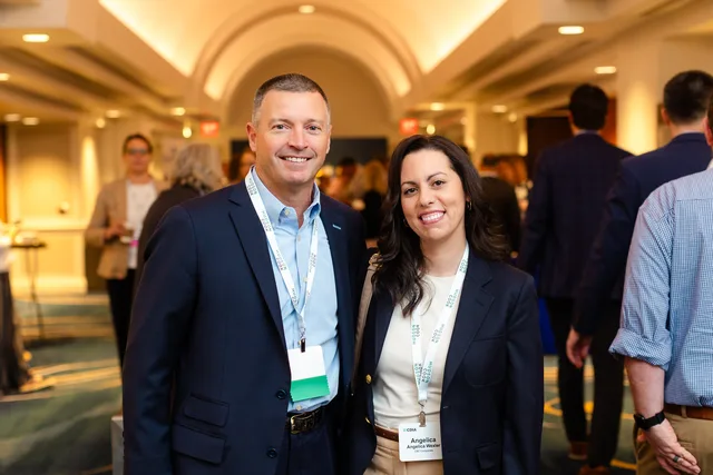Pair posed in the arched lobby.