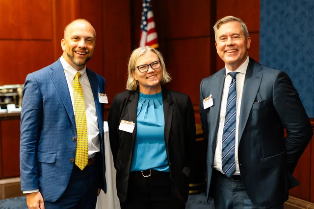 Three attendees laughing together.