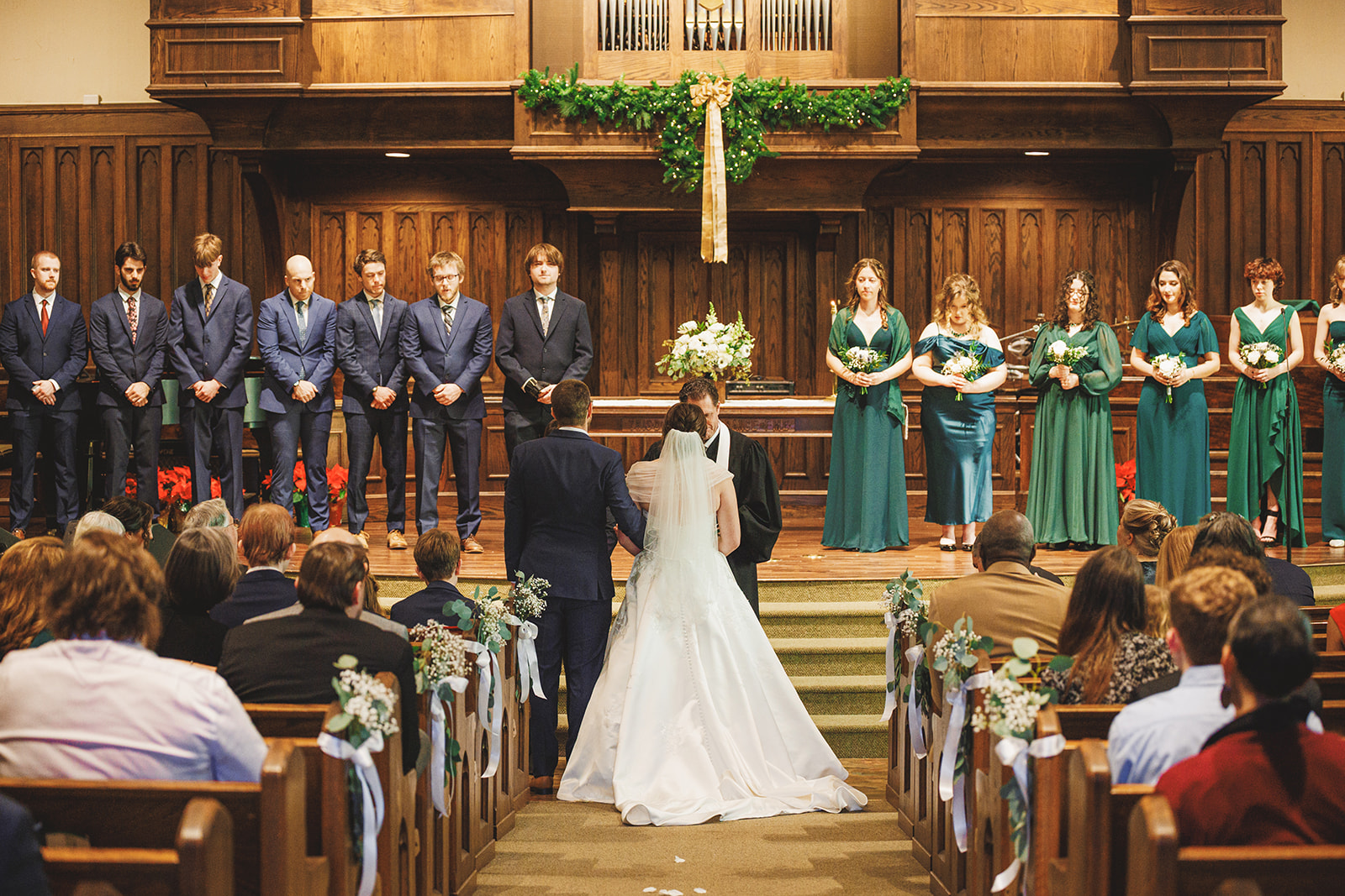 Aubrie and Elijah at the altar of First Presbyterian Church in Harrisonburg with their wedding party across the chancel