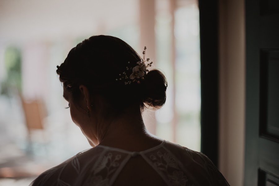 Alison from behind at a bright window, pearl pins in her hair and lace across her shoulders