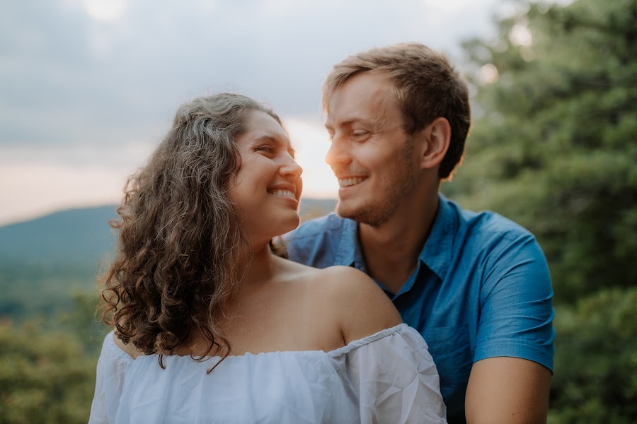 Ashley and Alan cheek to cheek in golden backlight above the valley at Weaverton Cliffs