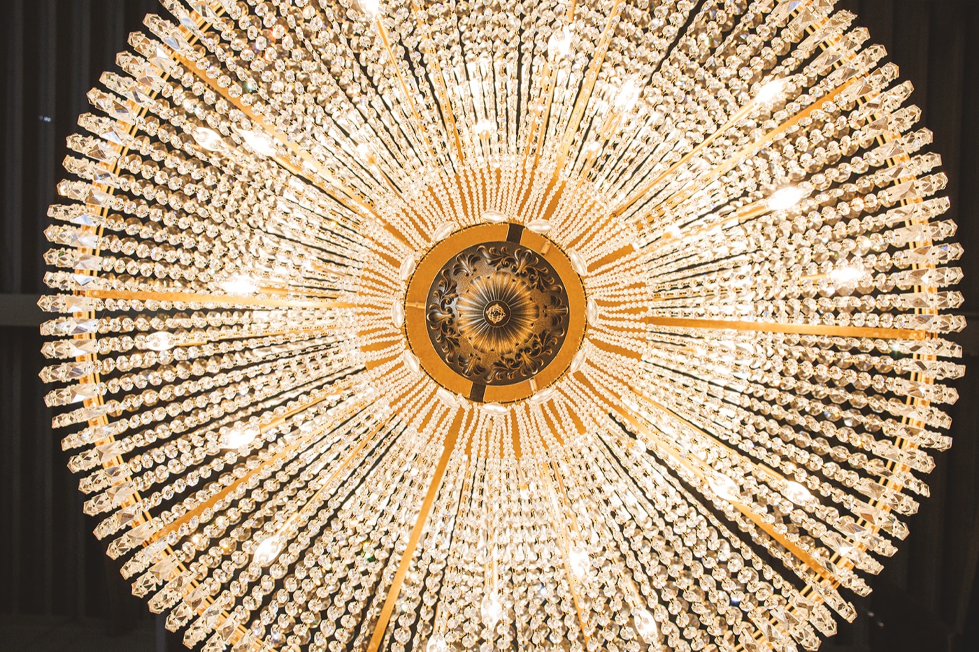 A crystal-and-gilt ballroom chandelier photographed symmetrically from directly below